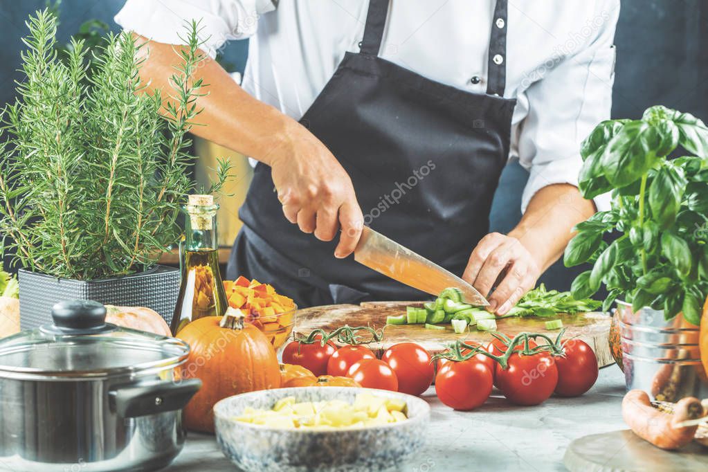 Chef cook preparing vegetables in his kitchen