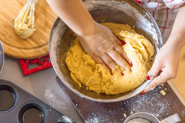 Christmas food concept. Woman is cooking gingerbread man cookies in Christmas close up.