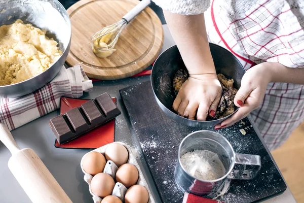 Christmas food concept. Woman is cooking gingerbread man cookies in Christmas close up.