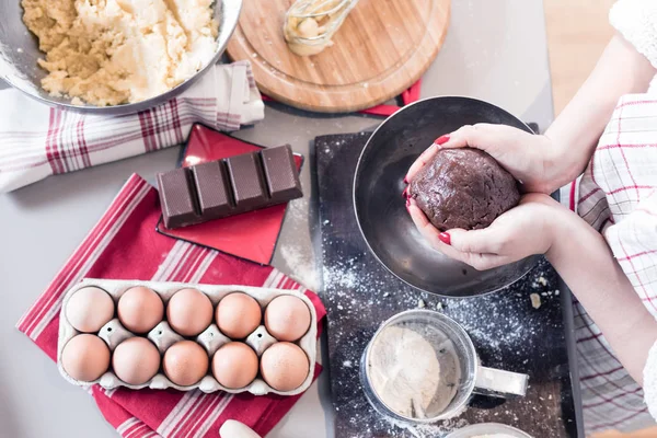 Christmas food concept. Woman is cooking gingerbread man cookies in Christmas close up.