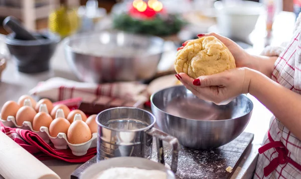 Christmas food concept. Woman is cooking gingerbread man cookies in Christmas close up.