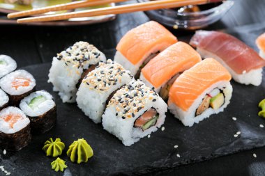 Suşi Sashimi ve suşi ruloları taş levhada servis edilir.