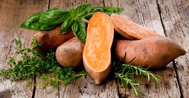 Sweet potato on Wooden background  clipart