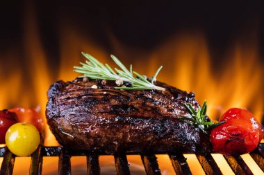 Fresh fillet steak on Grill with flammes  clipart