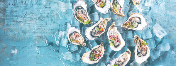 Fresh raw oysters and lemon on ice Cubes