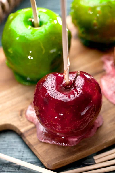 Table with colored candy apples