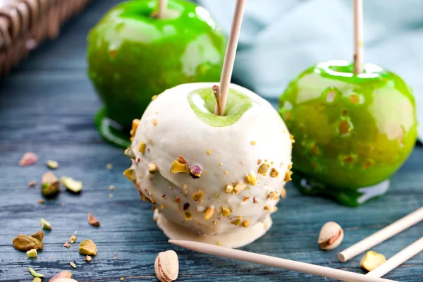 Table with colored candy apples