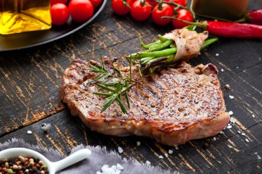 Fresh grilled meat. Grilled beef steak medium rare on wooden cutting board. Top view. clipart