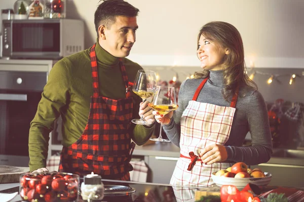 Couple celebrating Christmas in the kitchen cooking christmas duck or Goose