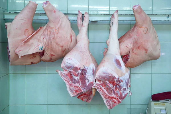 The meat Department at the market. Buyers and sellers in the market. Raw pork.