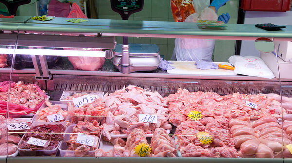 The meat Department at the market. Buyers and sellers in the market. Raw pork.