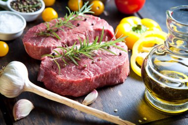 Koyu ahşap masada çiğ biftek..