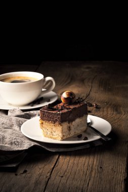 bir fincan kahve ile ahşap masa üzerinde çikolatalı kek