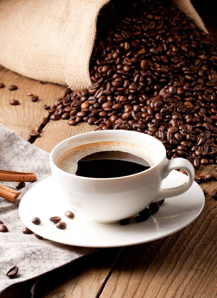 cup of coffee and  cake on coffee beans.