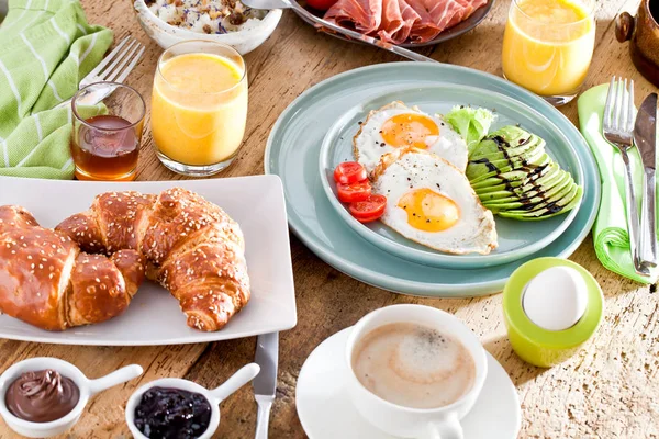 Homemade delicious american breakfast on dark wooden table