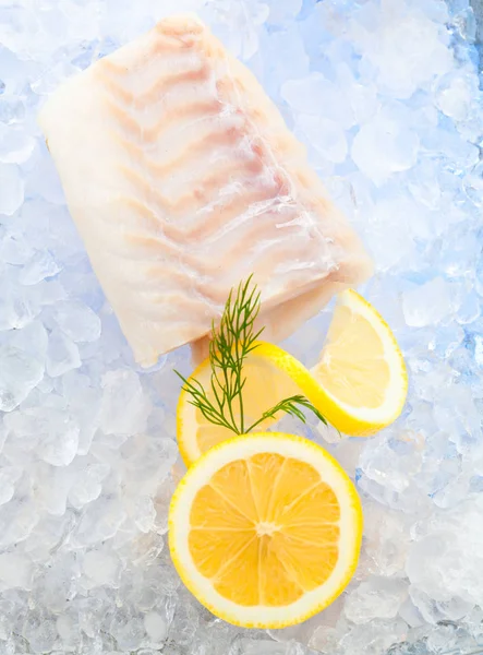 Cod fish fillets on ice with fresh Lemon