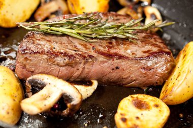 Izgara siyah Angus biftek kızartma ahşap arka plan üzerinde dökme demir ızgara tava üzerinde Striploin