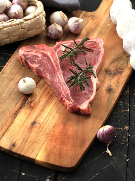 Raw Bone Steak Seasoned Spices Fresh Herbs Served Wooden Board — Stock Photo, Image