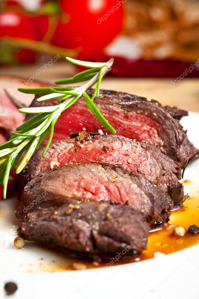 grilled venison fillet on wooden table close up