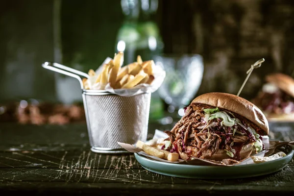 homemade pulled pork burger with bbq sauce close up