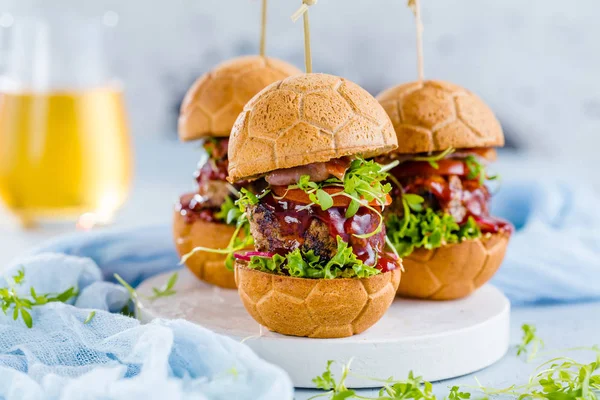 fresh delicious burgers in Form of Football (soccer)