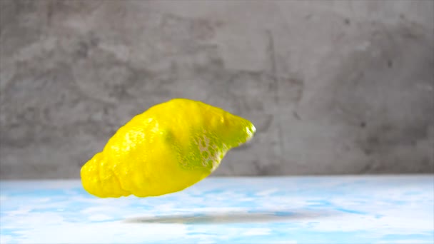 Целый Спелый Лимон Падает Синий Стол — стоковое видео