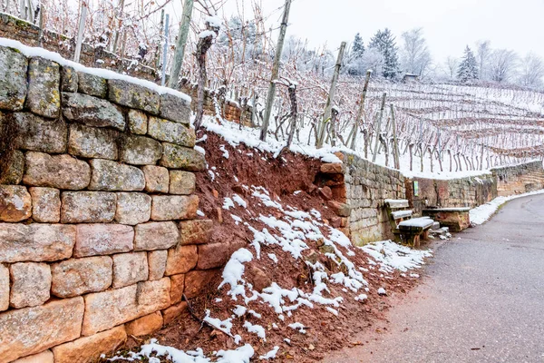 Broken Stone wall in vineyard water and snow damage