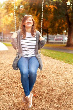 Bahçesi, salıncak üzerinde dinlenme gülümseyen güzel kadın