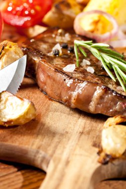 taze sebze ve bıçak ile lezzetli ızgara biftek ahşap kesme tahtası üzerinde görmek