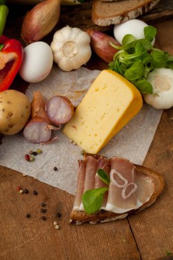 Çeşitli sebze, peynir ve ham ahşap masa, rustik arka plan üzerinde