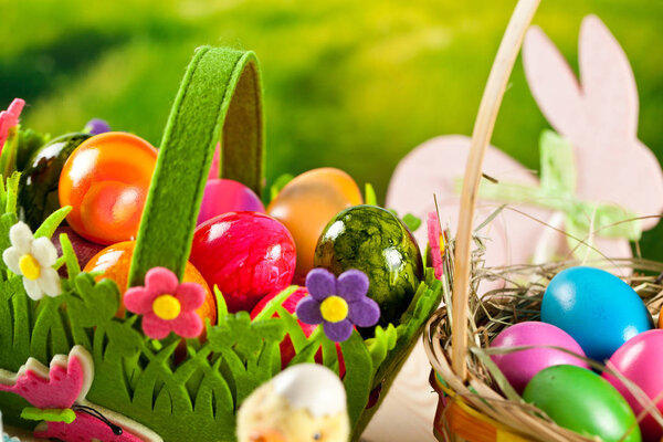 close-up view of decorative baskets with colorful painted easter eggs and easter bunny