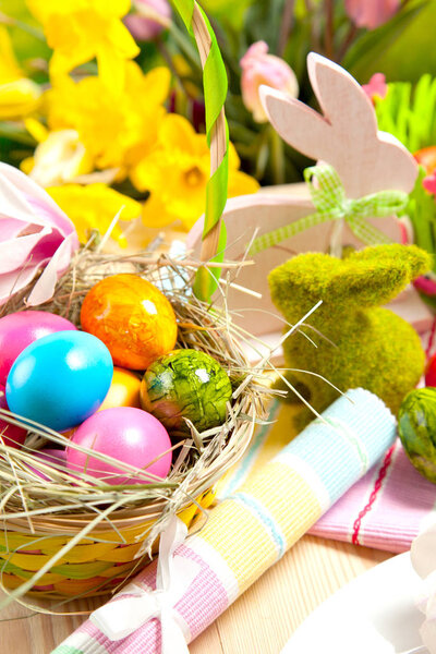 close-up view of decorative wicker basket with colorful painted easter eggs  