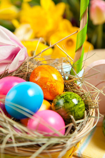 close-up view of decorative easter basket with colorful painted eggs  