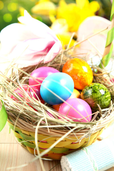 close-up view of beautiful wicker basket with colorful easter eggs 