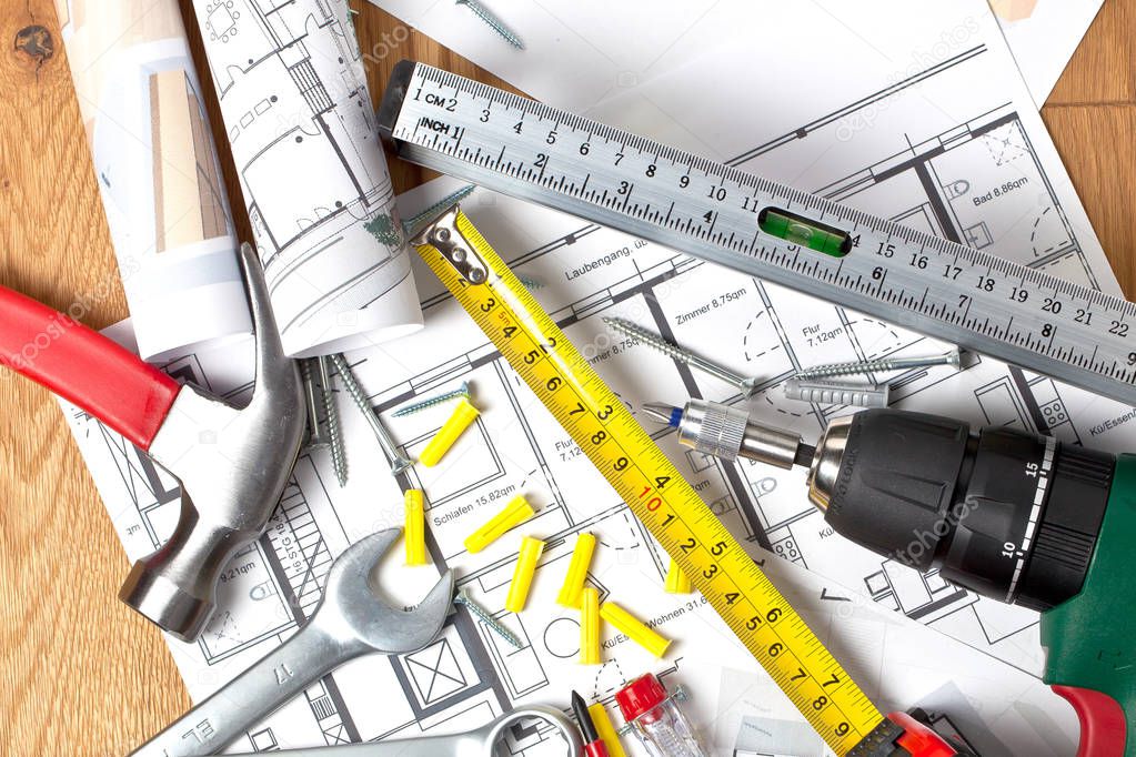 close-up view of blueprint and various construction tools on table, maintenance concept 