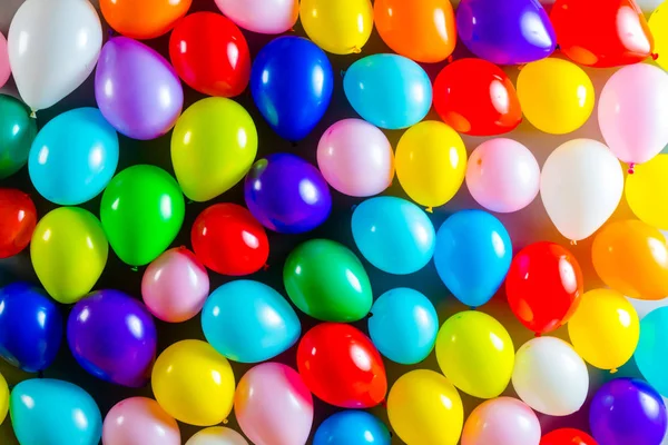 Colorful party balloon background with dozens of balloons