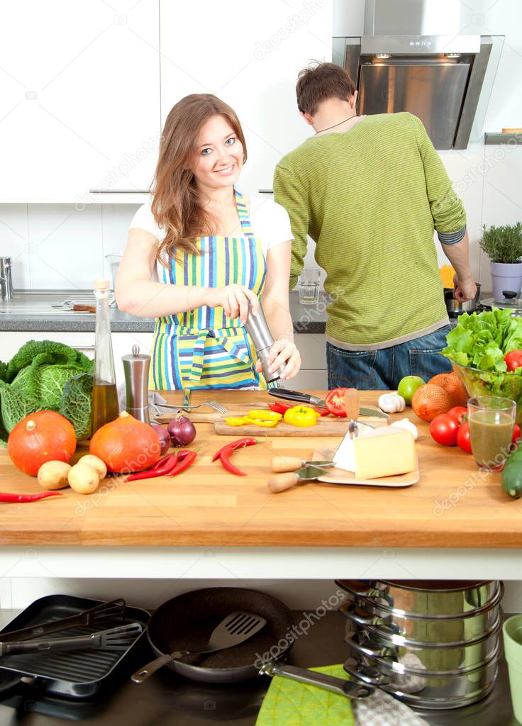 Happy young couple preparing healthy food together in kitchen. Healthy food concept