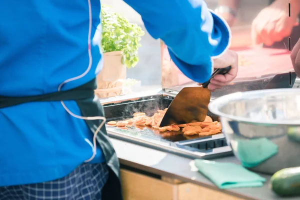 Cropped shot of chef cooking in restaurant kitchen