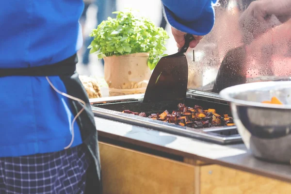 Cropped shot of chef cooking in restaurant kitchen