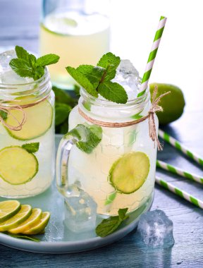 limonata, içme pipetleri, nane, buz küpleri ve limon ile mason kavanoz yakın çekim görünümü    