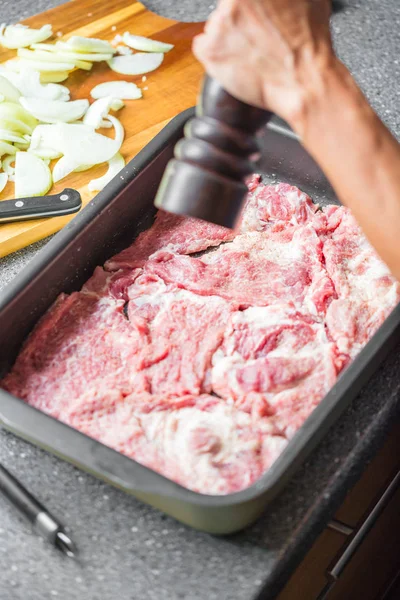Cropped shot of person salting delicious uncooked meat in baking tray — Stock Image Cropped Shot Person Salting Delicious Uncooked Meat Baking Tray Stock Photo