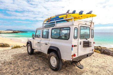 Sörf tahtaları ve deniz kıyısında güzel plajları olan bir araba.