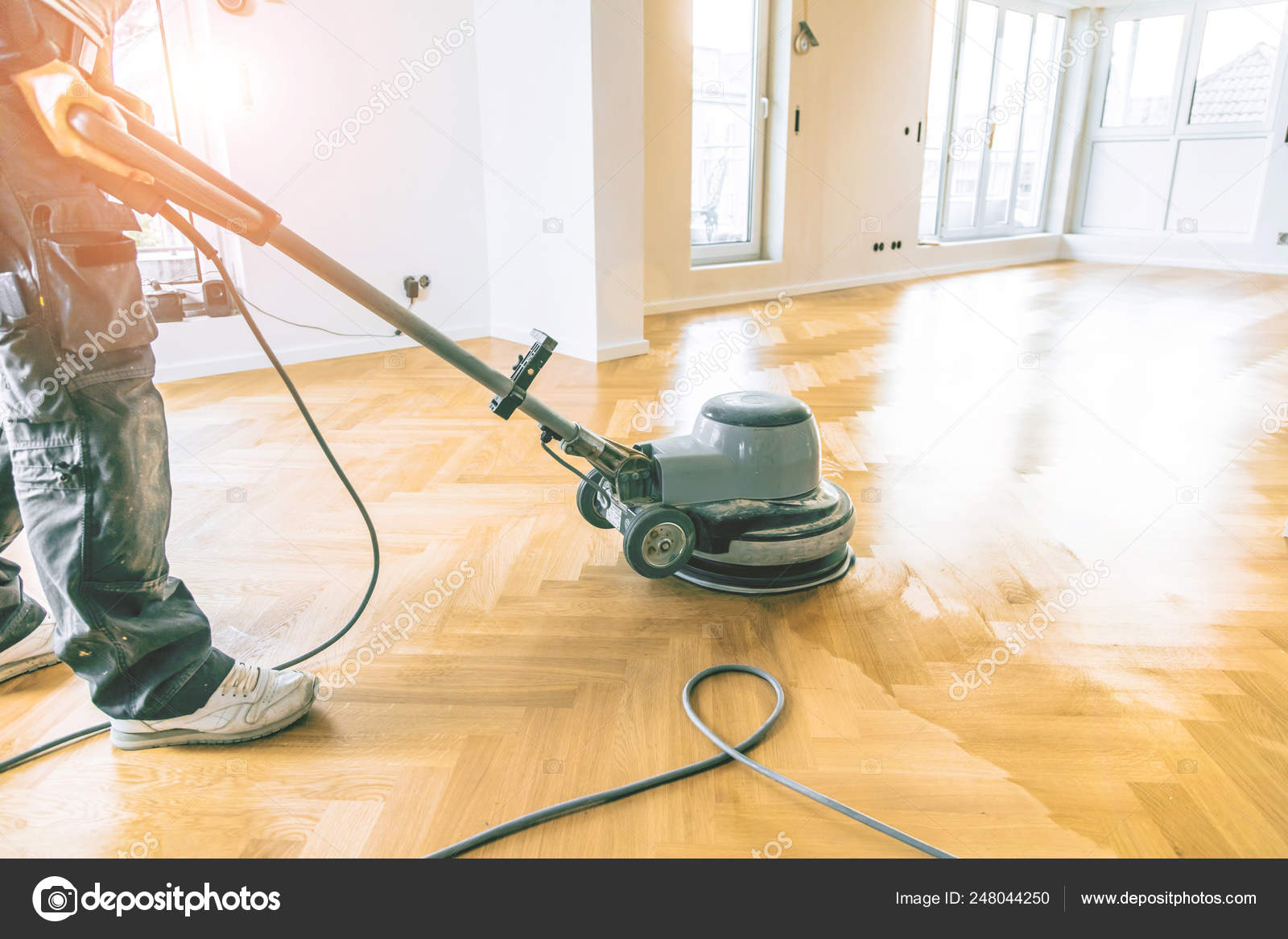 Young Man Varnishing Oak Parquet Floor Tool Stock Photo