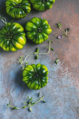 Bütün taze yeşil domates en iyi görünümü gri arka plan üzerinde
