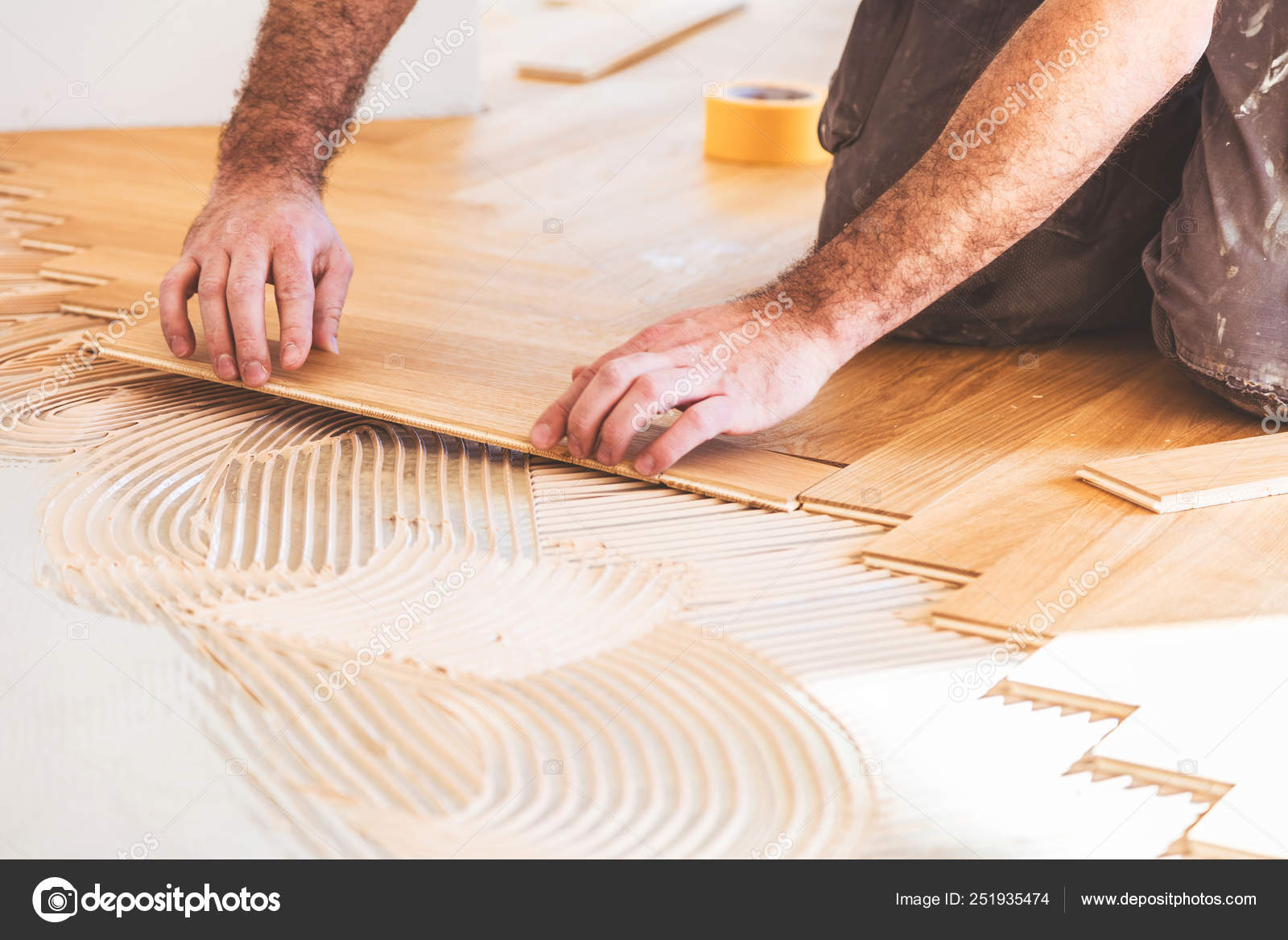 Male Worker Varnishing Oak Parquet Floor Home Improvement Stock