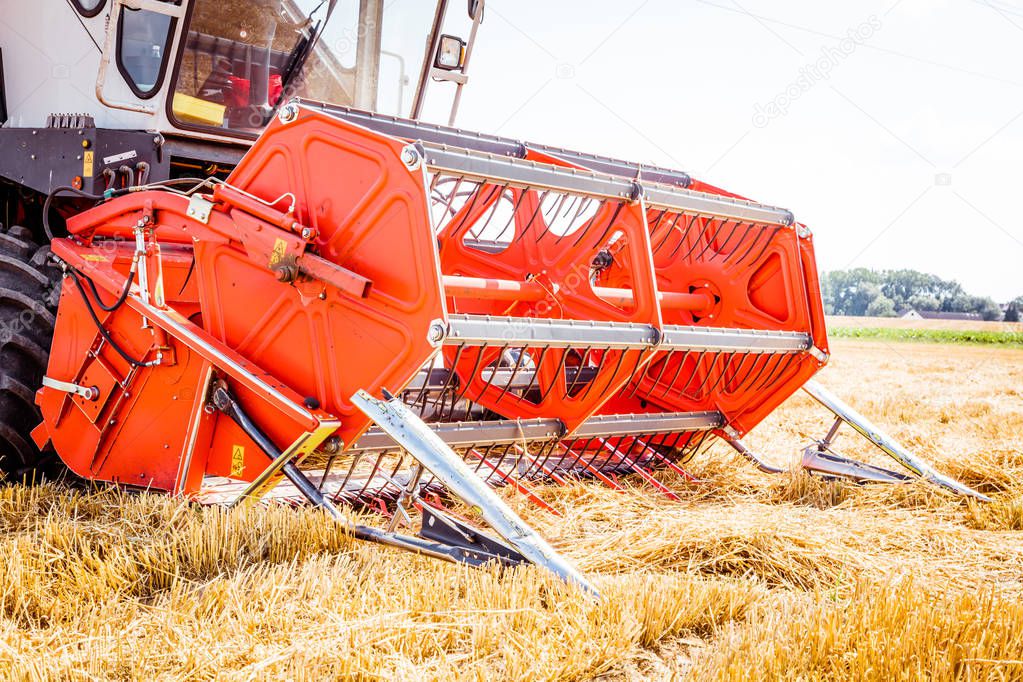 agricultural machine for harvesting grain crops on farm field, close-up view