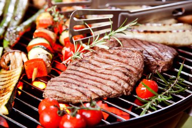 barbekü üzerinde kömürler üzerinde sebze ile biftek ve sosis yakın çekim görünümü 