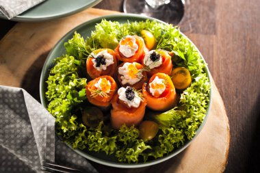 tabakta krem peynir, dereotu, havyar ve marul ile lezzetli somon rulo üst görünümü