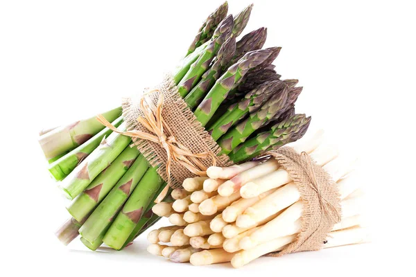 bunches of fresh ripe green and white asparagus on white background
