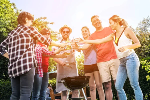 Diverse People Friends Hanging Out in Backyard, Drinking Beer and Cooking Barbeque
